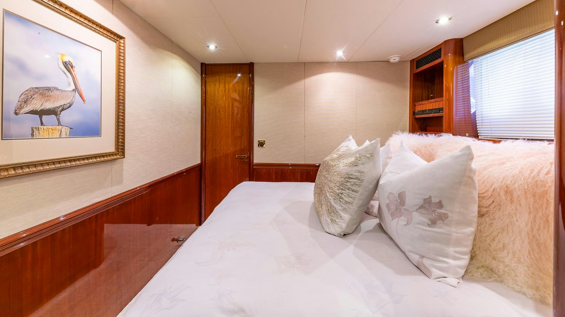 a bed with white sheets and pillows aboard HOPE FLOATS Yacht for Sale