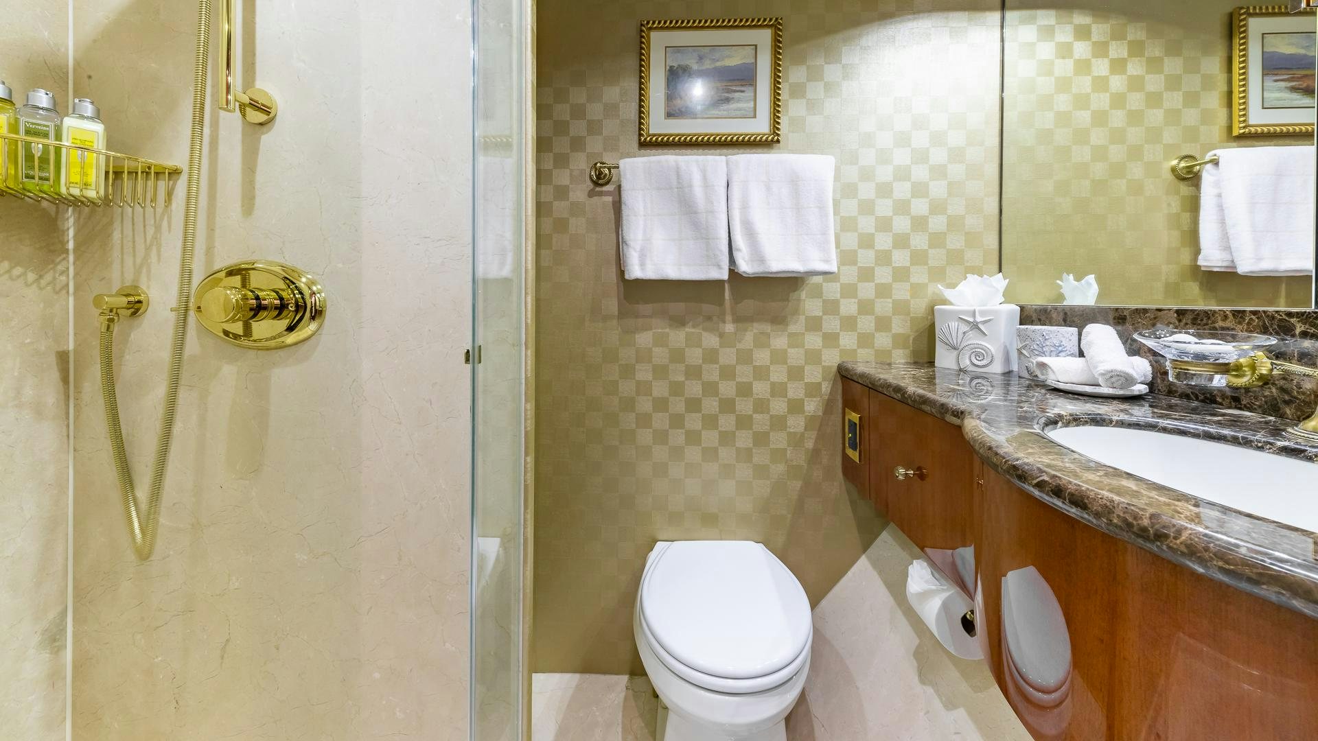 a bathroom with a sink toilet and a mirror aboard HOPE FLOATS Yacht for Sale