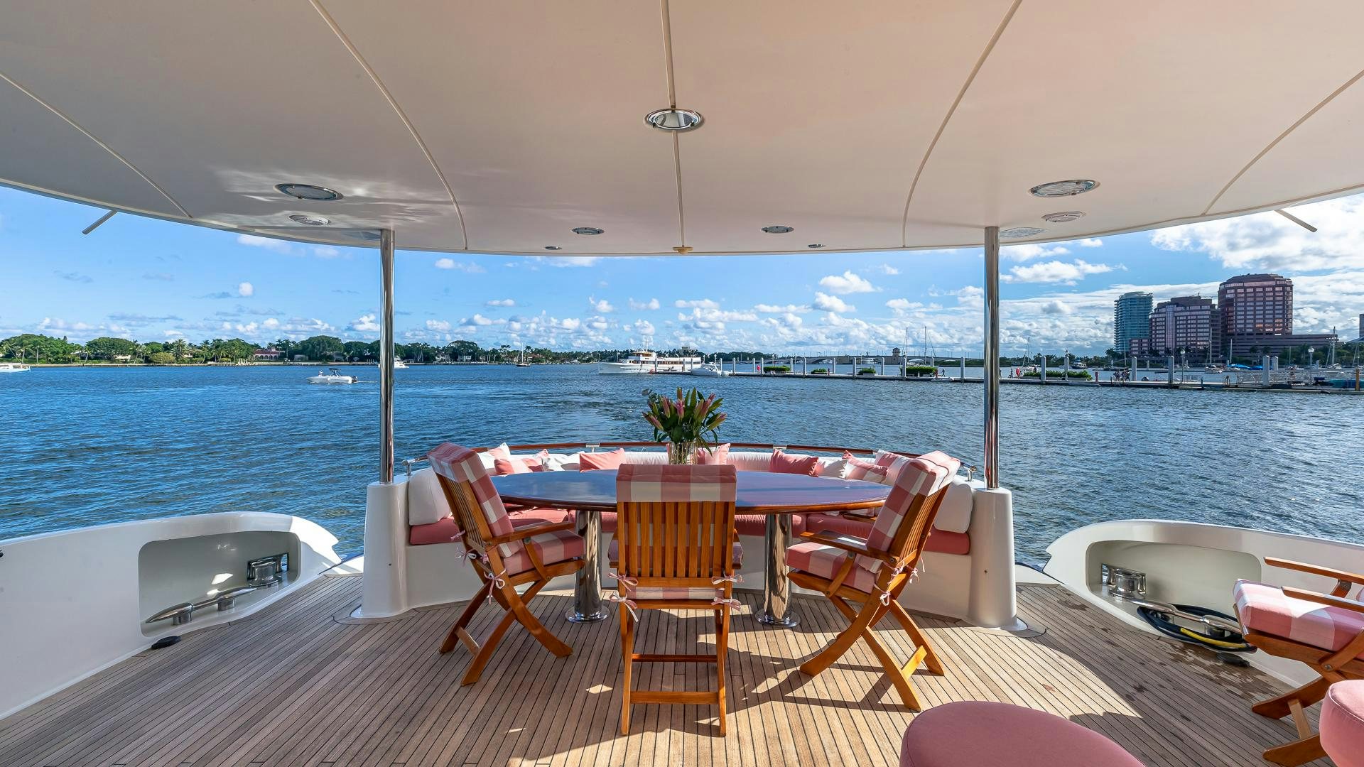 a table and chairs on a deck overlooking a body of water aboard HOPE FLOATS Yacht for Sale