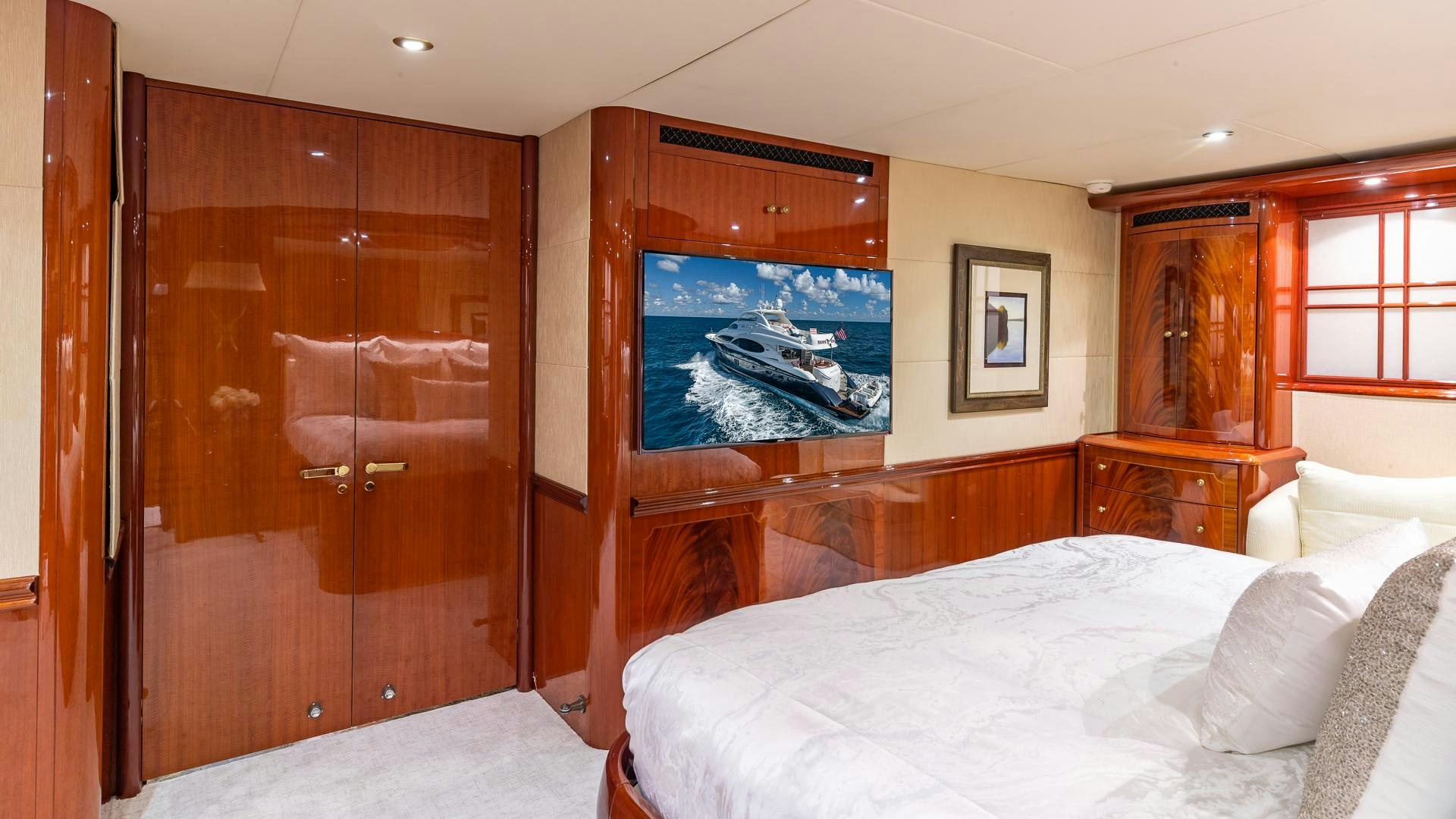a bedroom with a bed and a television aboard HOPE FLOATS Yacht for Sale