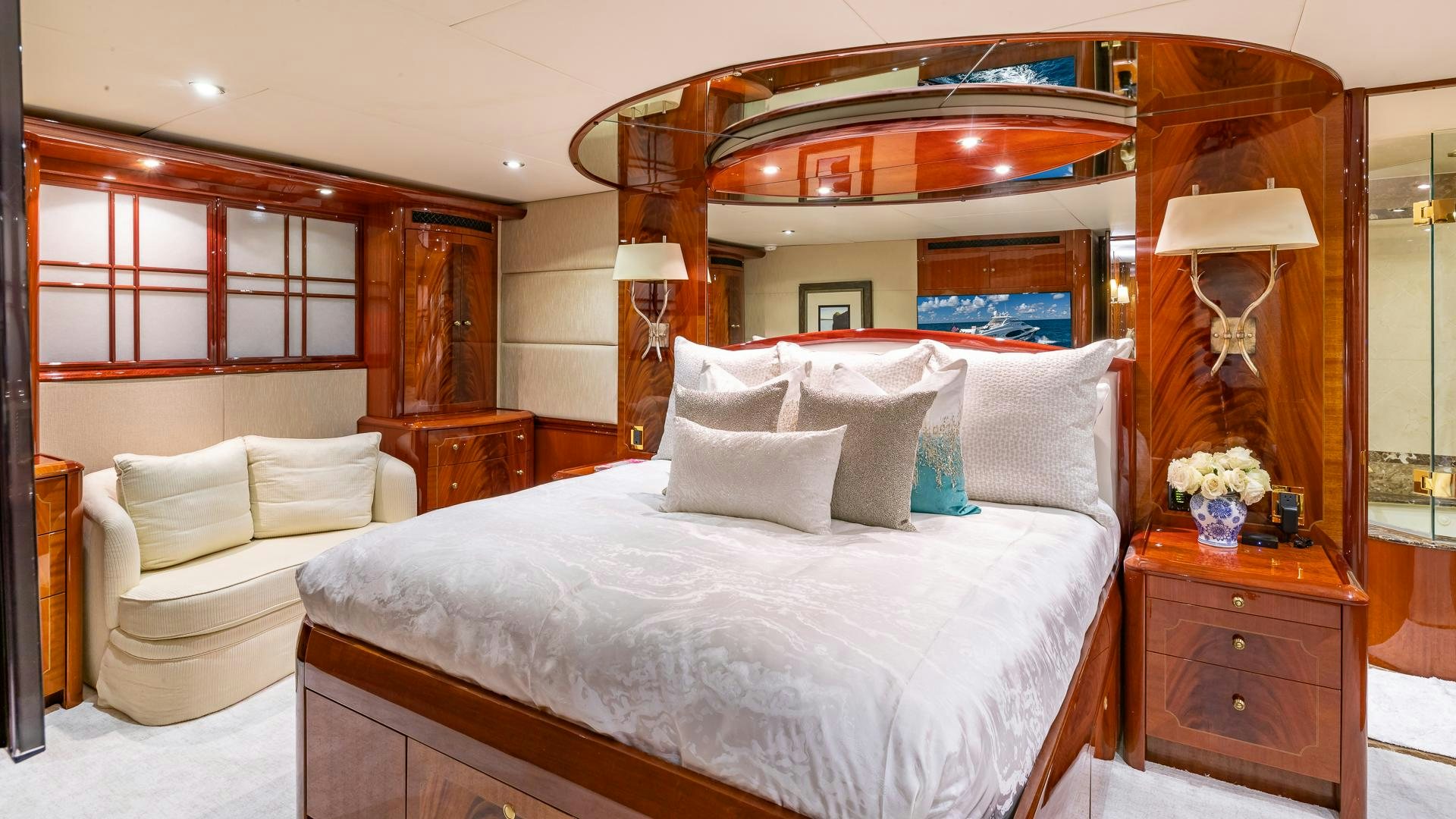 a bed with a white bed spread aboard HOPE FLOATS Yacht for Sale