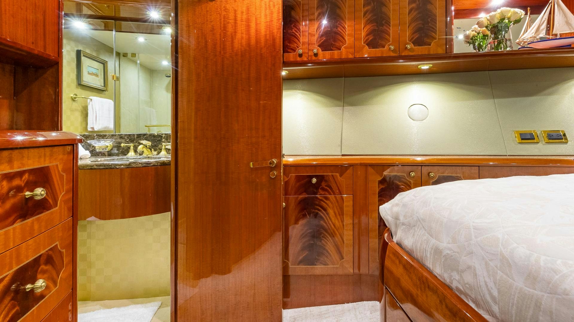 a room with a bed and a mirror aboard HOPE FLOATS Yacht for Sale