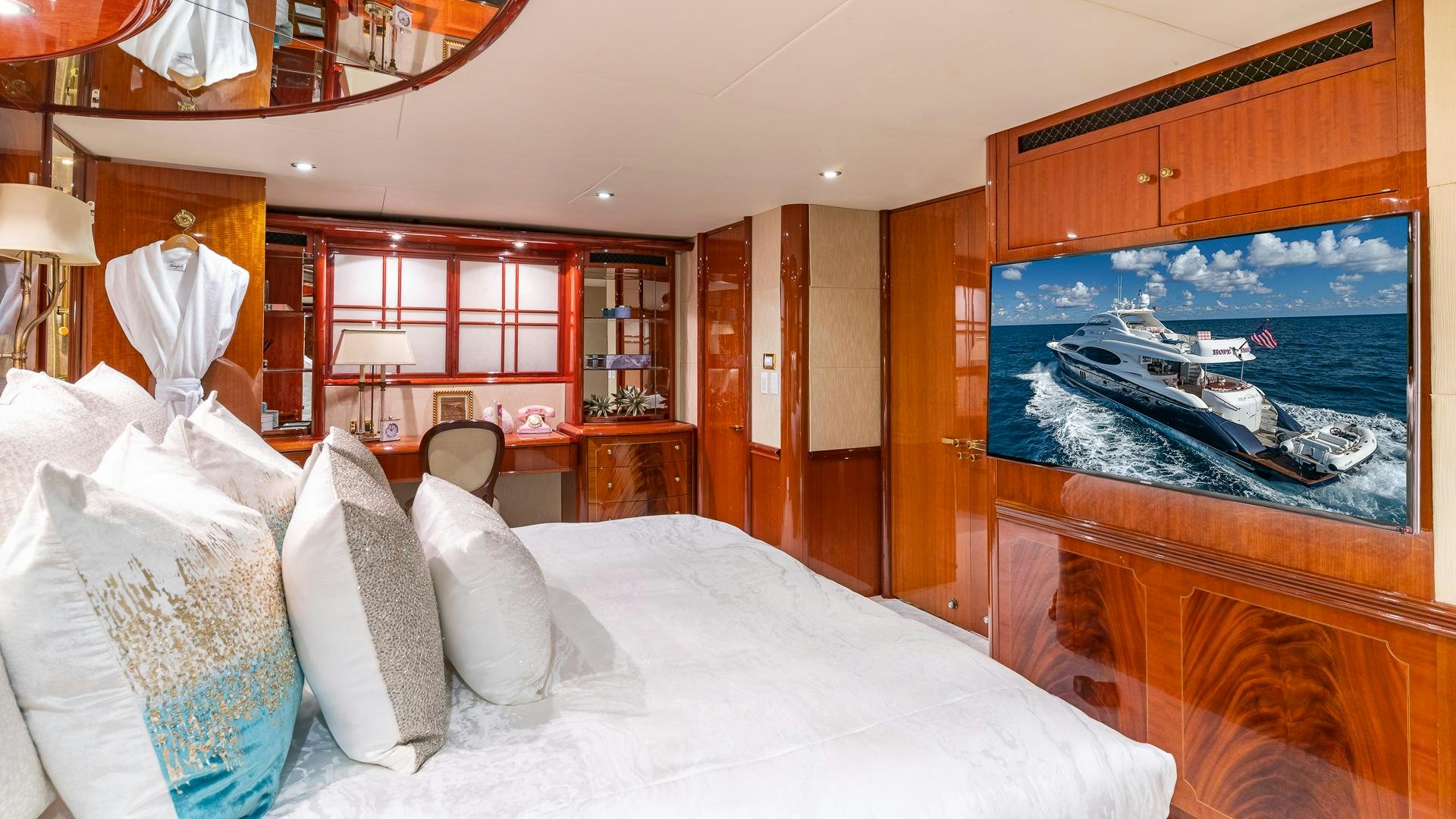 a room with a bed and a painting on the wall aboard HOPE FLOATS Yacht for Sale