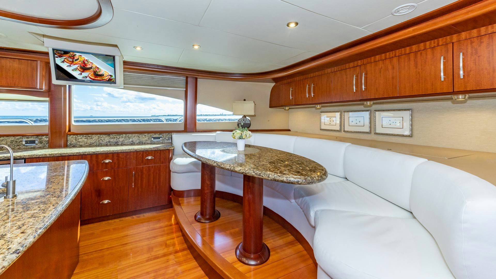 a living room with a white couch and wooden cabinets aboard HOPE FLOATS Yacht for Sale
