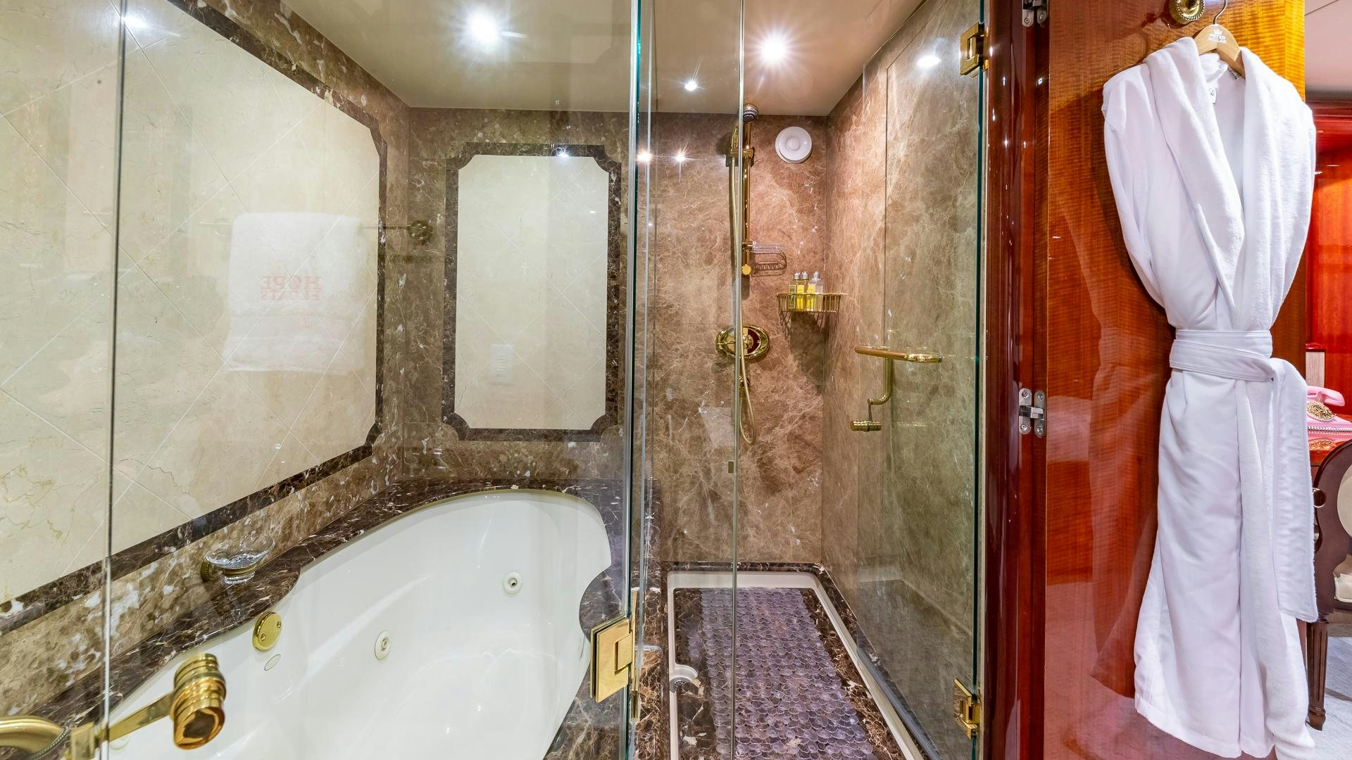 a bathroom with a bathtub and a shower aboard HOPE FLOATS Yacht for Sale