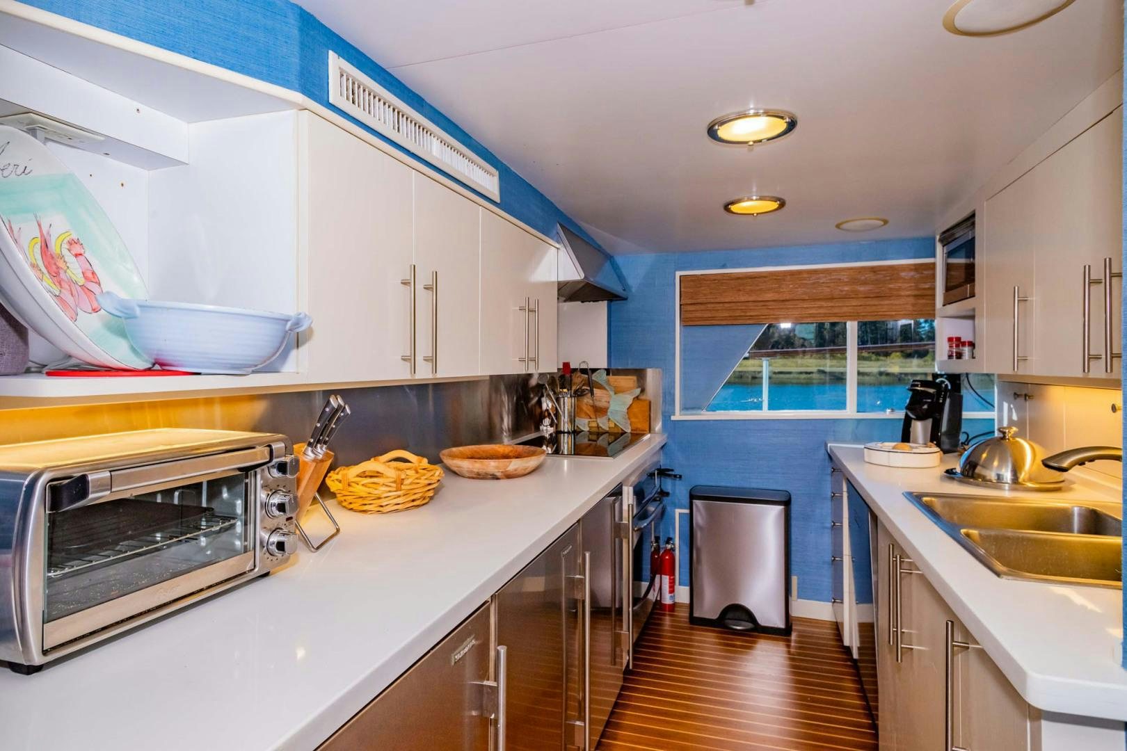a kitchen with a sink and stove aboard FREEDOM Yacht for Sale