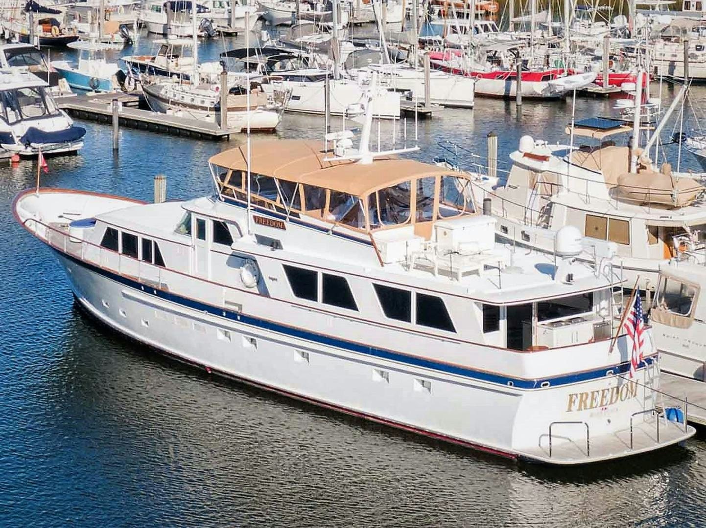 a large white boat in a harbor aboard FREEDOM Yacht for Sale
