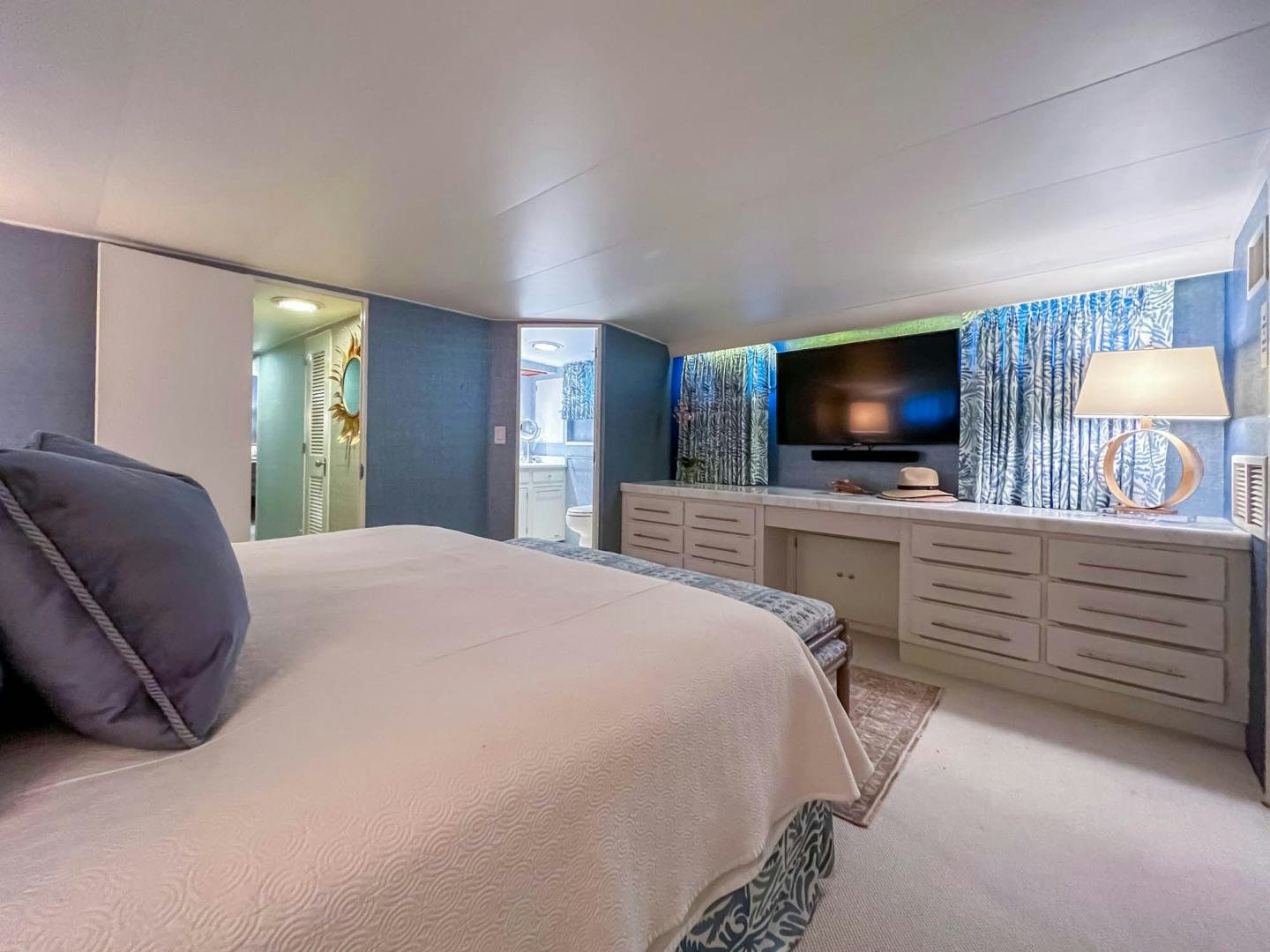 a bedroom with a bed and a tv aboard FREEDOM Yacht for Sale