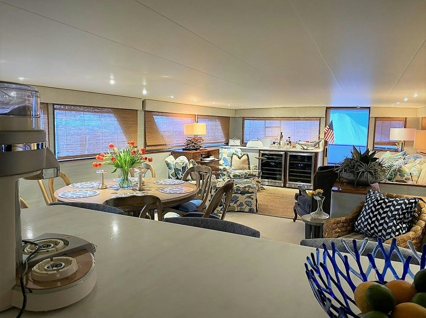 a living room with a table and chairs aboard FREEDOM Yacht for Sale