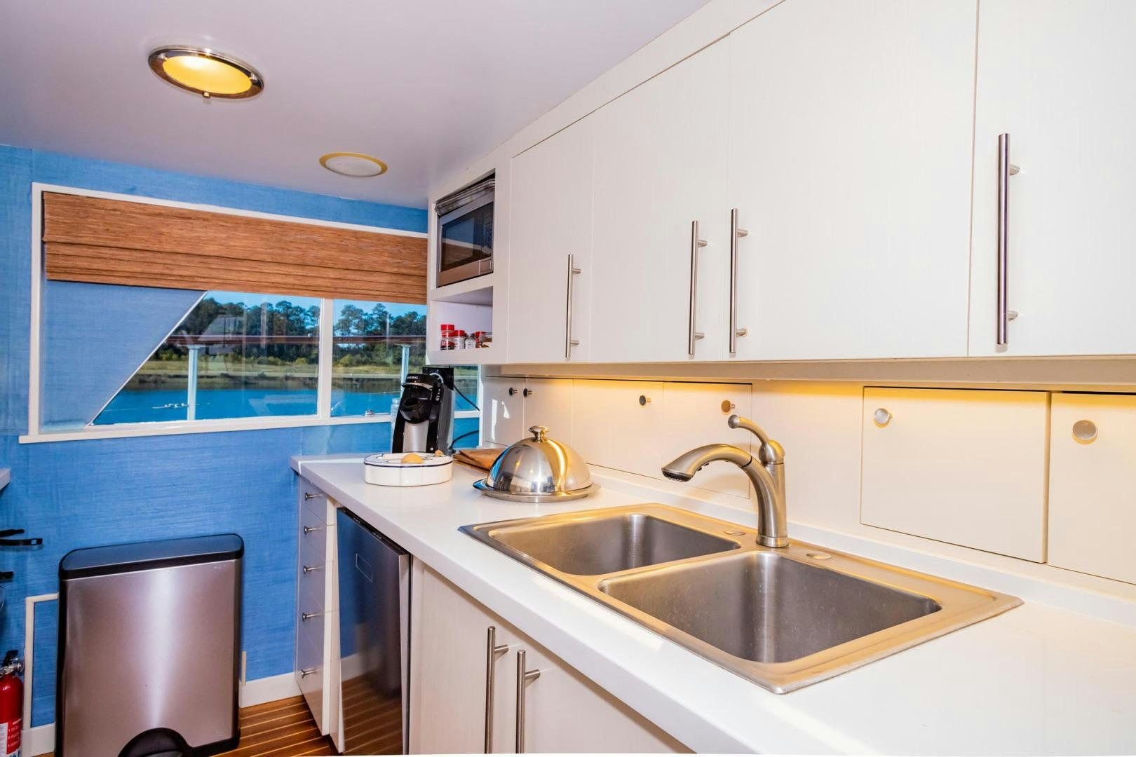 a kitchen with a sink and a window aboard FREEDOM Yacht for Sale