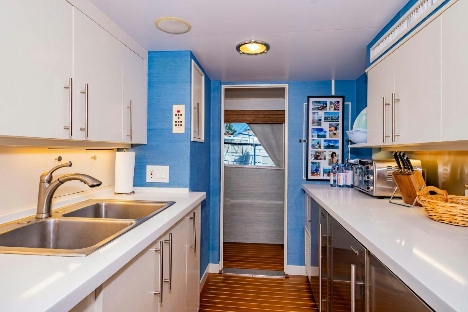 a kitchen with blue walls aboard FREEDOM Yacht for Sale