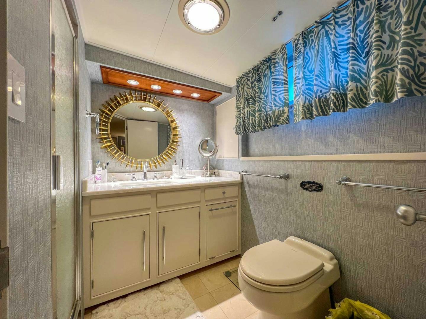 a bathroom with a blue shower curtain aboard FREEDOM Yacht for Sale