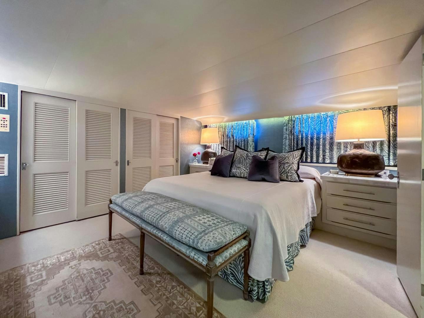 a bedroom with a bed and a lamp on the wall aboard FREEDOM Yacht for Sale