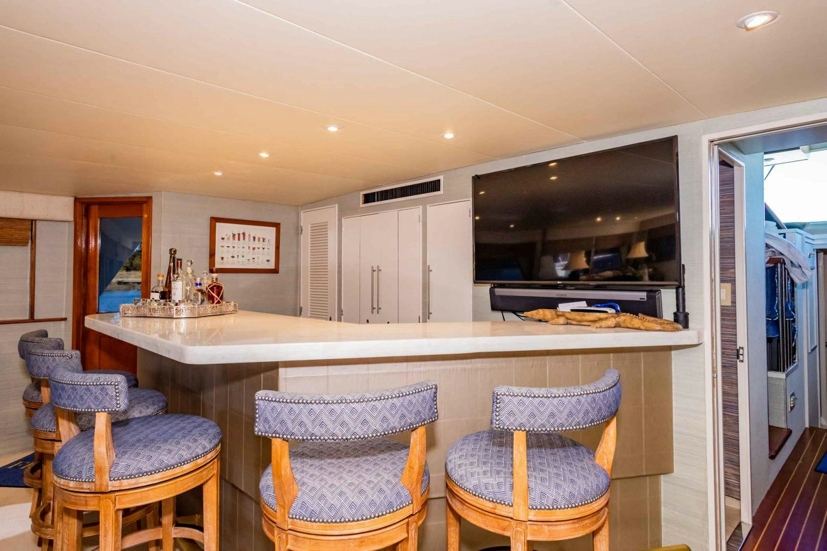 a kitchen with a bar and chairs aboard FREEDOM Yacht for Sale