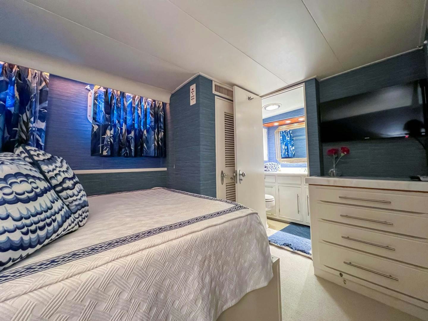 a bedroom with a blue wall aboard FREEDOM Yacht for Sale