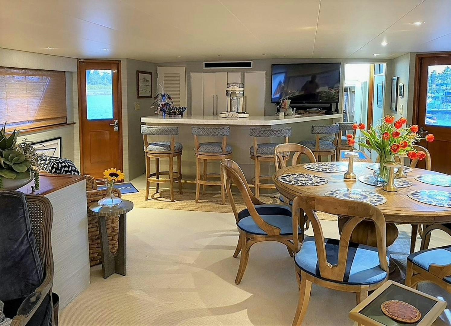 a kitchen with a table and chairs aboard FREEDOM Yacht for Sale