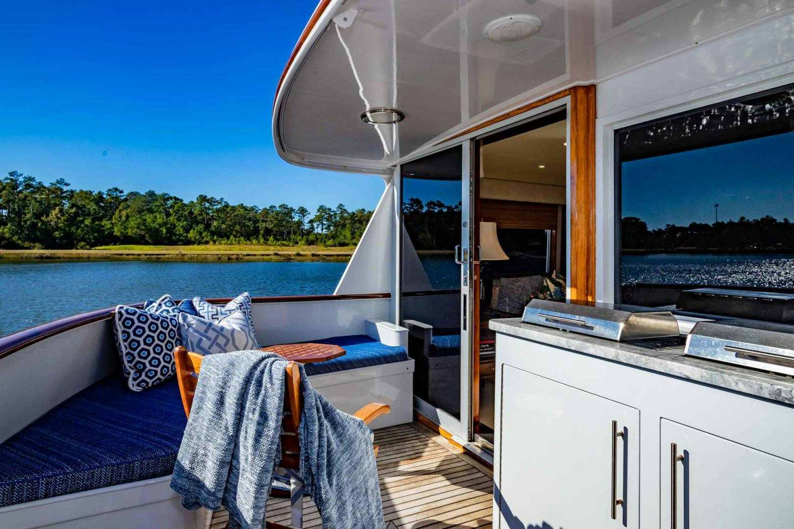 a boat with a bed and a chair on the deck aboard FREEDOM Yacht for Sale