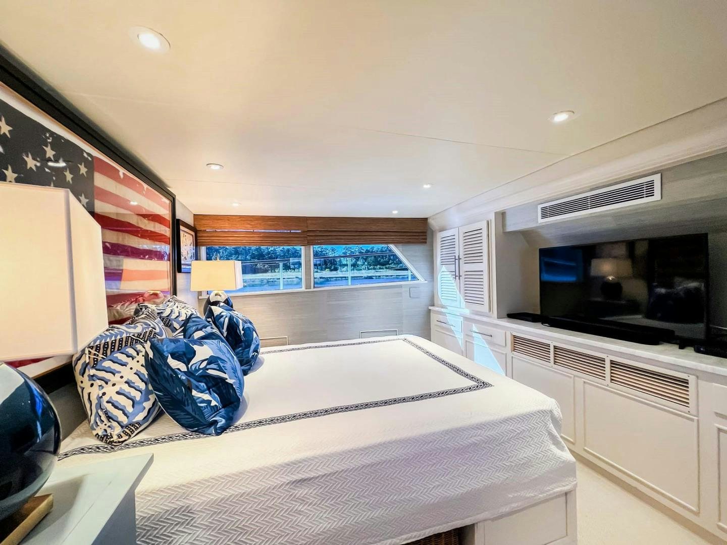 a bedroom with a bed and a television aboard FREEDOM Yacht for Sale