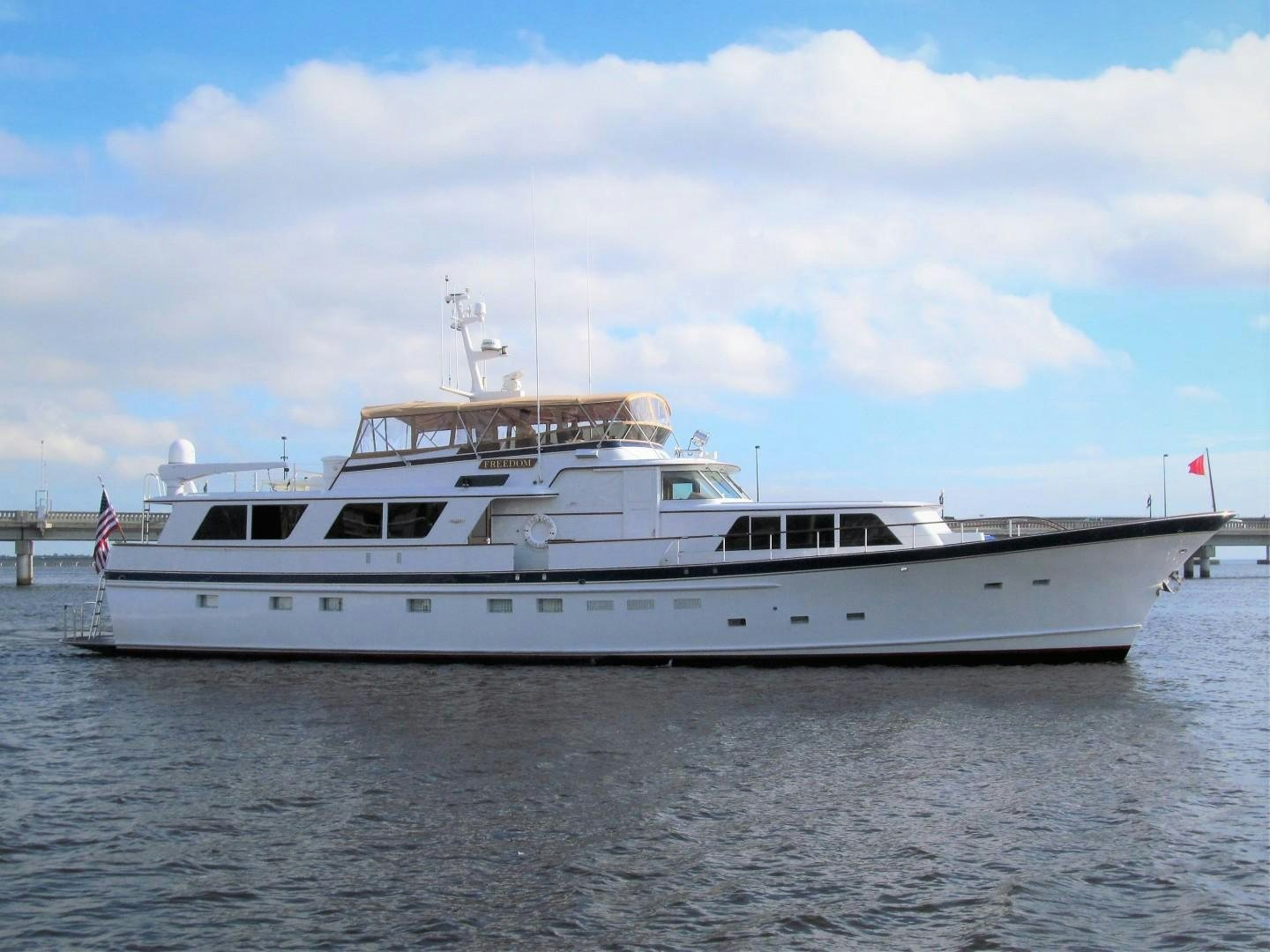 a white boat on the water aboard FREEDOM Yacht for Sale