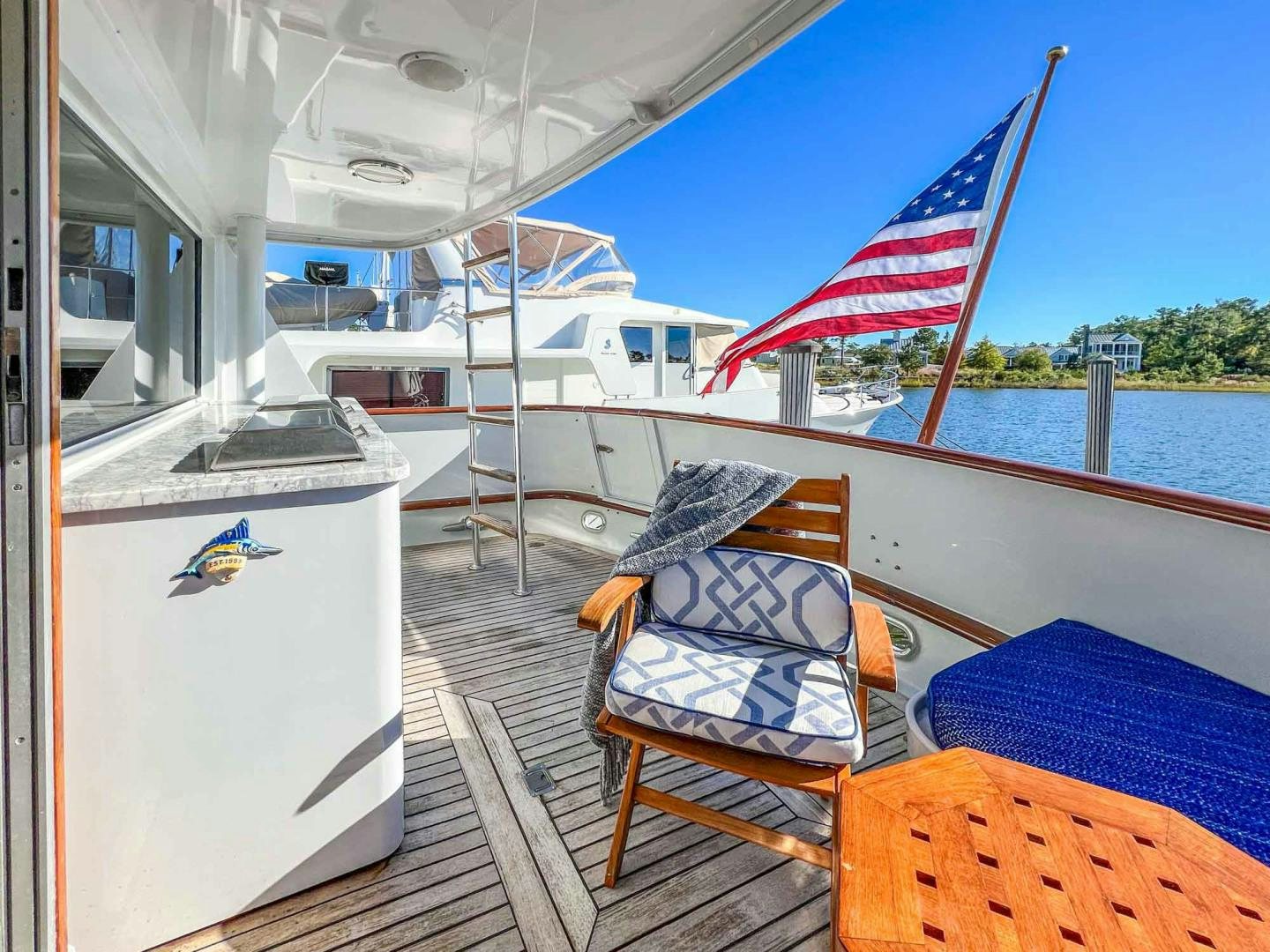 a boat with a flag on the deck aboard FREEDOM Yacht for Sale