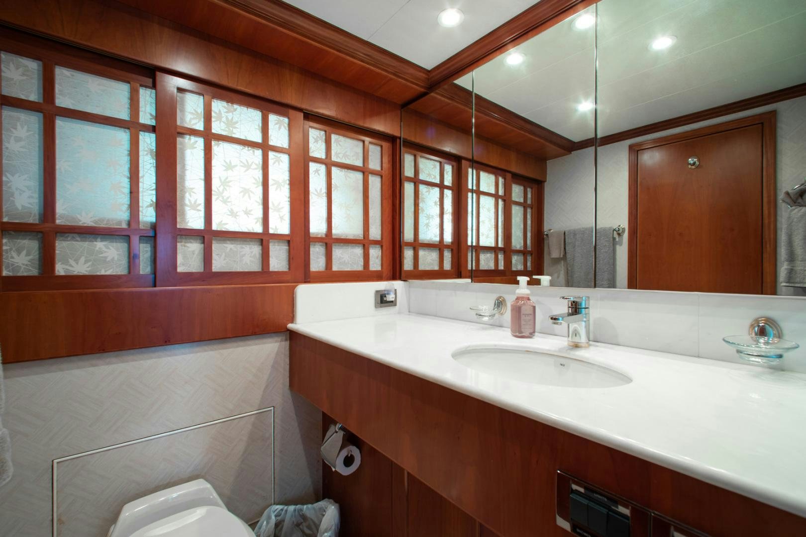 a bathroom with a tub sink and a large mirror aboard BOXES II Yacht for Sale