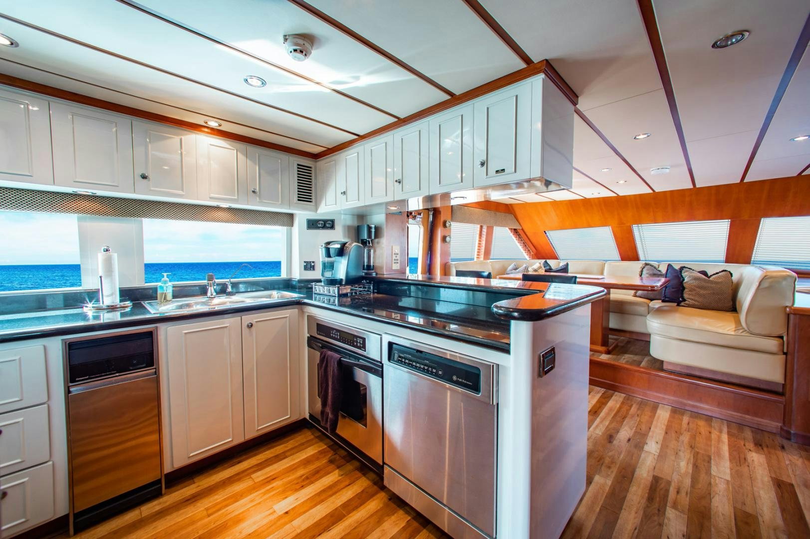 a kitchen with a couch and a table aboard BOXES II Yacht for Sale