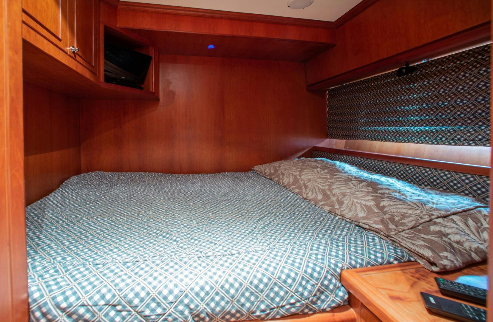 a bed with a white comforter aboard BOXES II Yacht for Sale