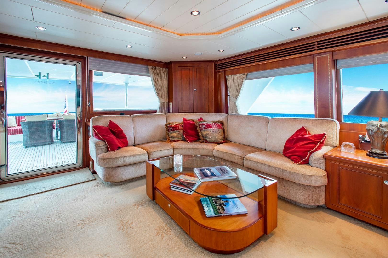 a living room with a couch and a coffee table aboard BOXES II Yacht for Sale