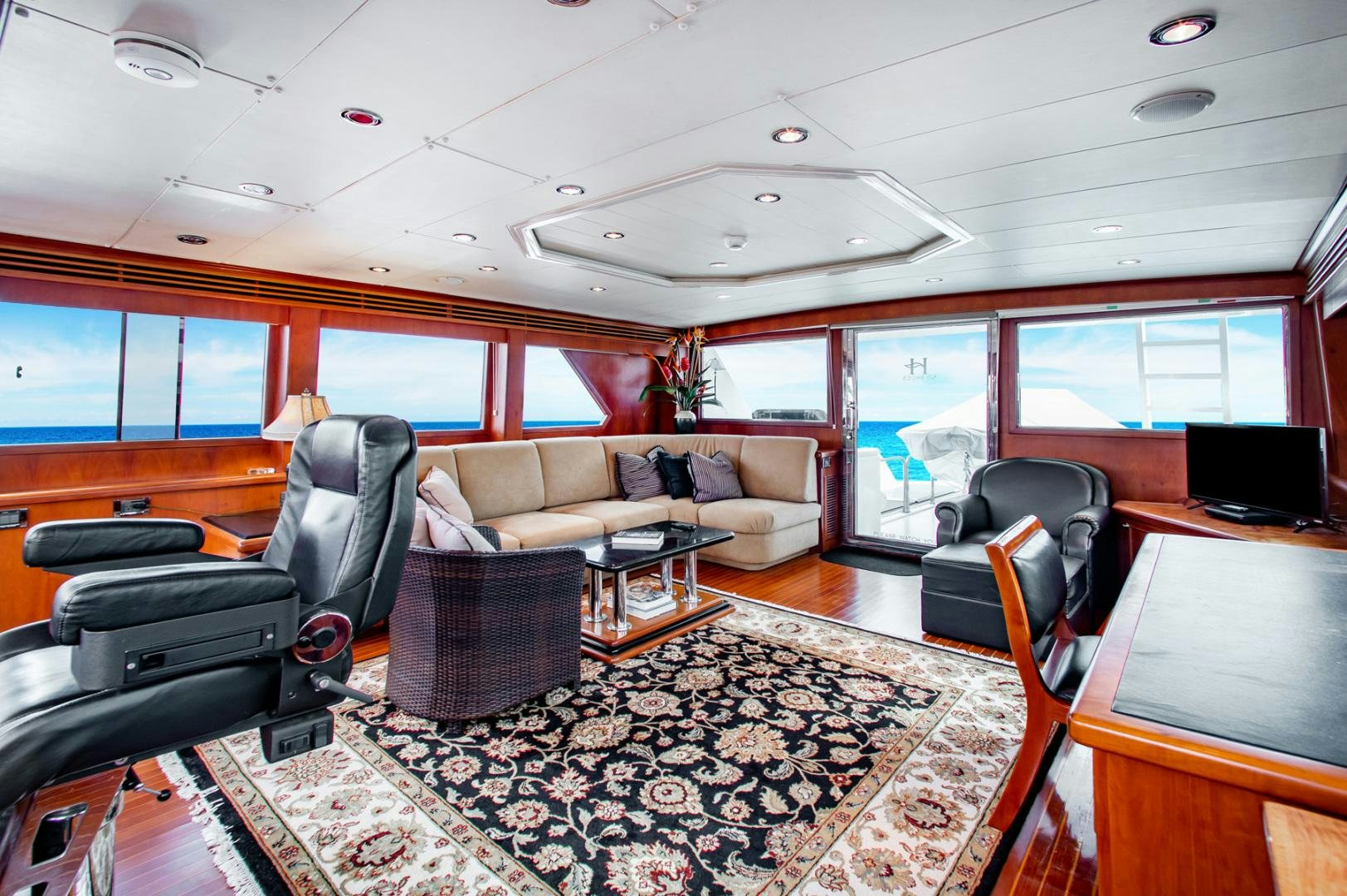 a living room with a couch and a table aboard BOXES II Yacht for Sale