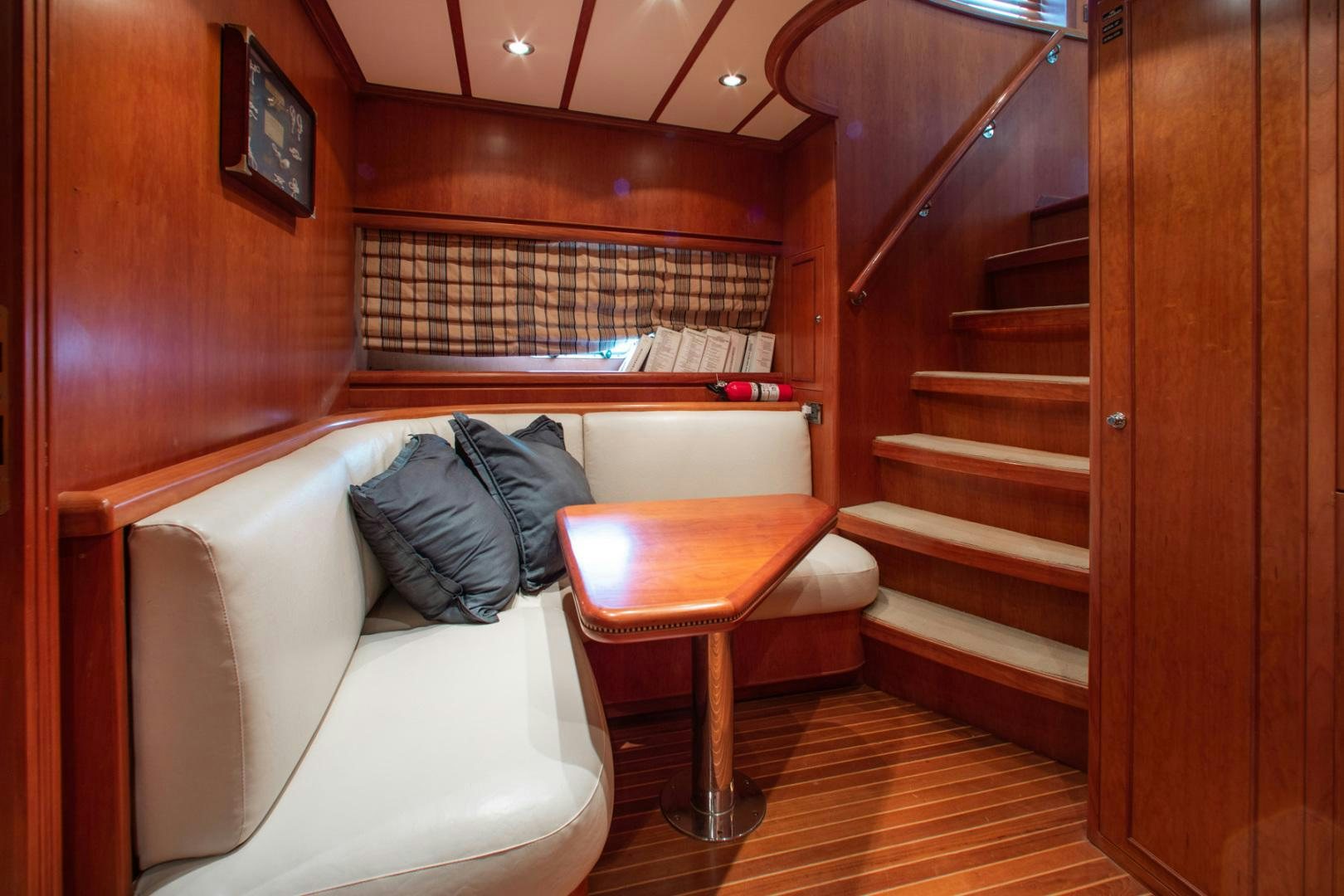 a room with a bed and a table aboard BOXES II Yacht for Sale
