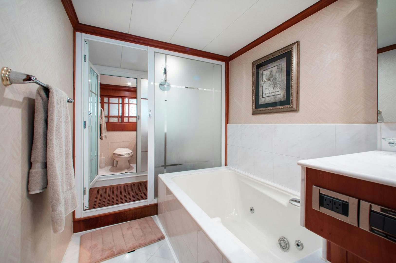 a bathroom with a bathtub and toilet aboard BOXES II Yacht for Sale