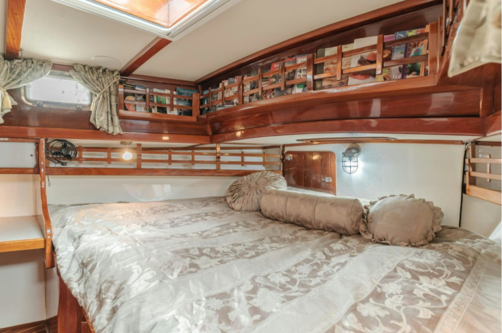a bed with pillows aboard Iolair Mara Yacht for Sale
