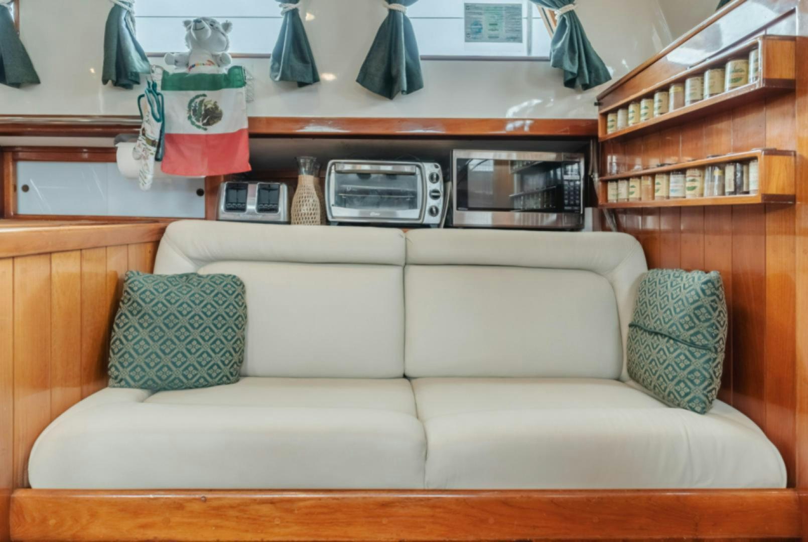 a couch with a laptop on top aboard Iolair Mara Yacht for Sale
