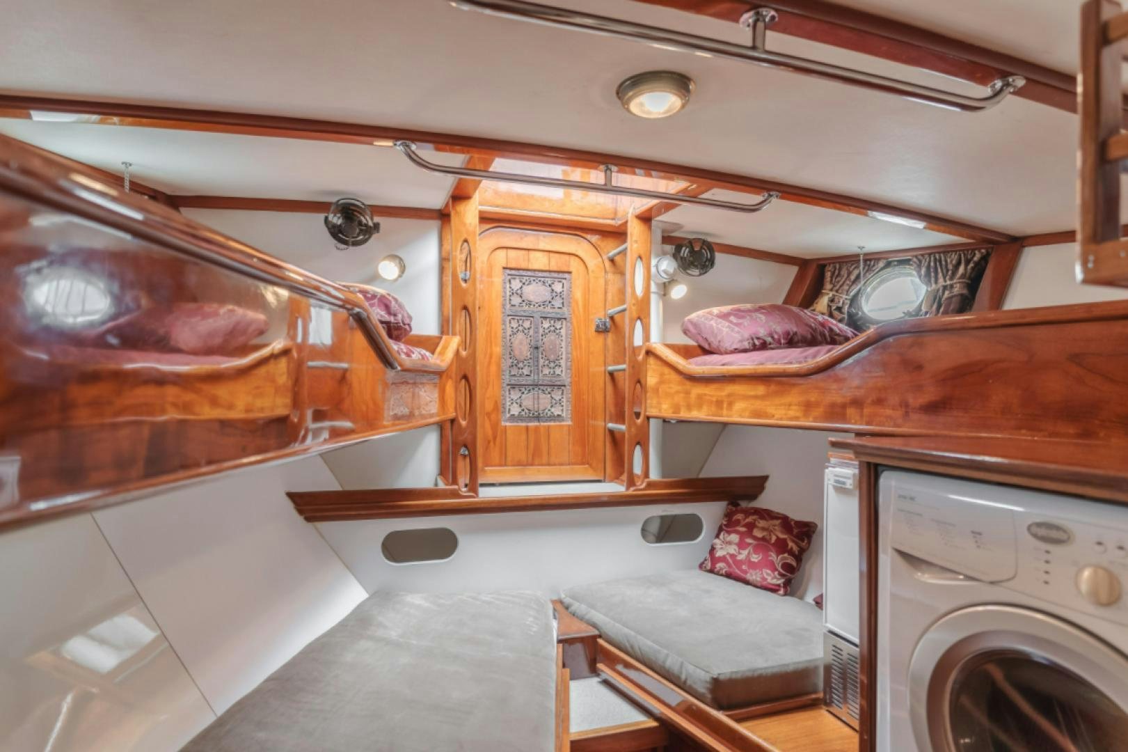 a small cabin with a bed and a washer aboard Iolair Mara Yacht for Sale
