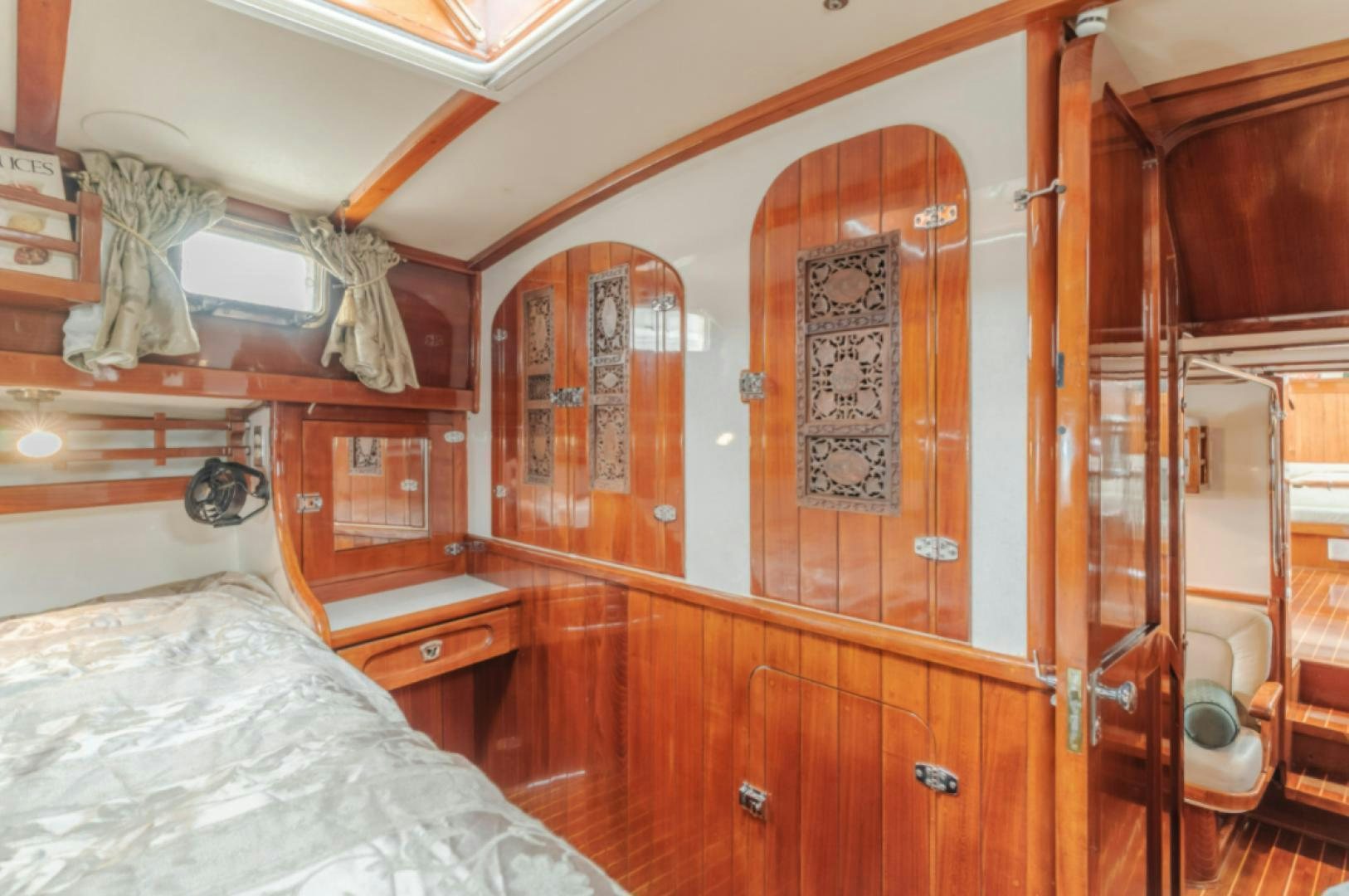 a bedroom with a bed and a closet aboard Iolair Mara Yacht for Sale