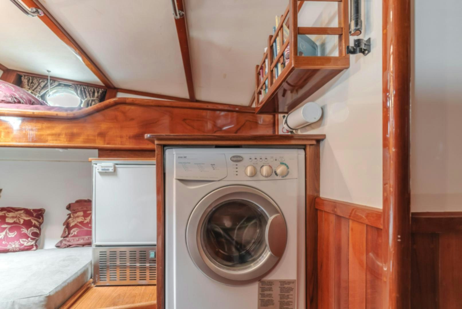 a room with a washing machine and a bed aboard Iolair Mara Yacht for Sale