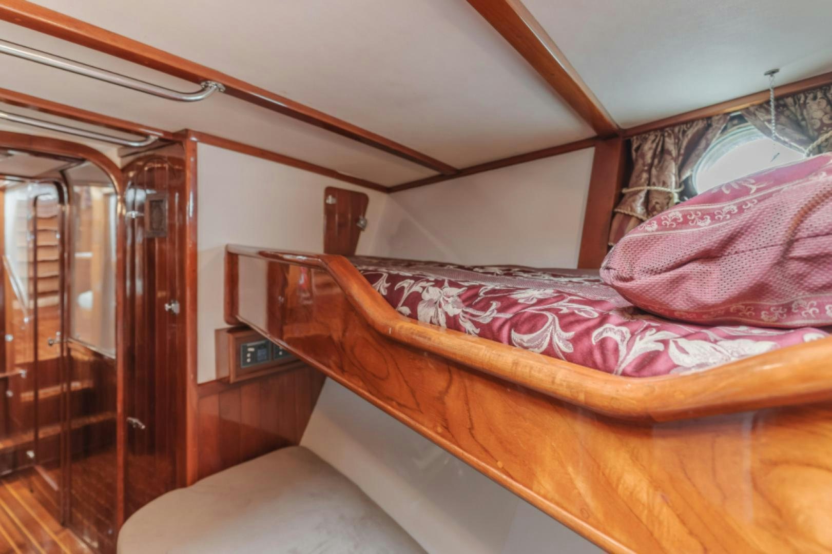 a bed with a pink comforter aboard Iolair Mara Yacht for Sale