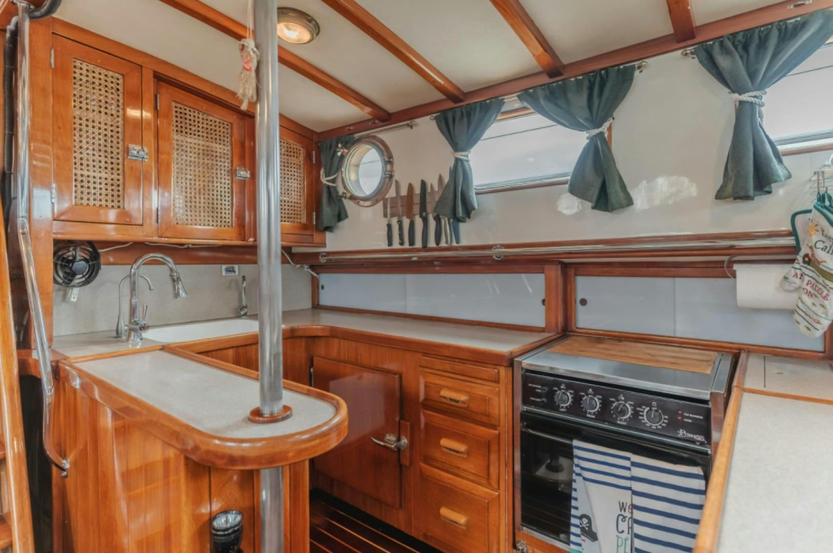 a kitchen with a stove and sink aboard Iolair Mara Yacht for Sale