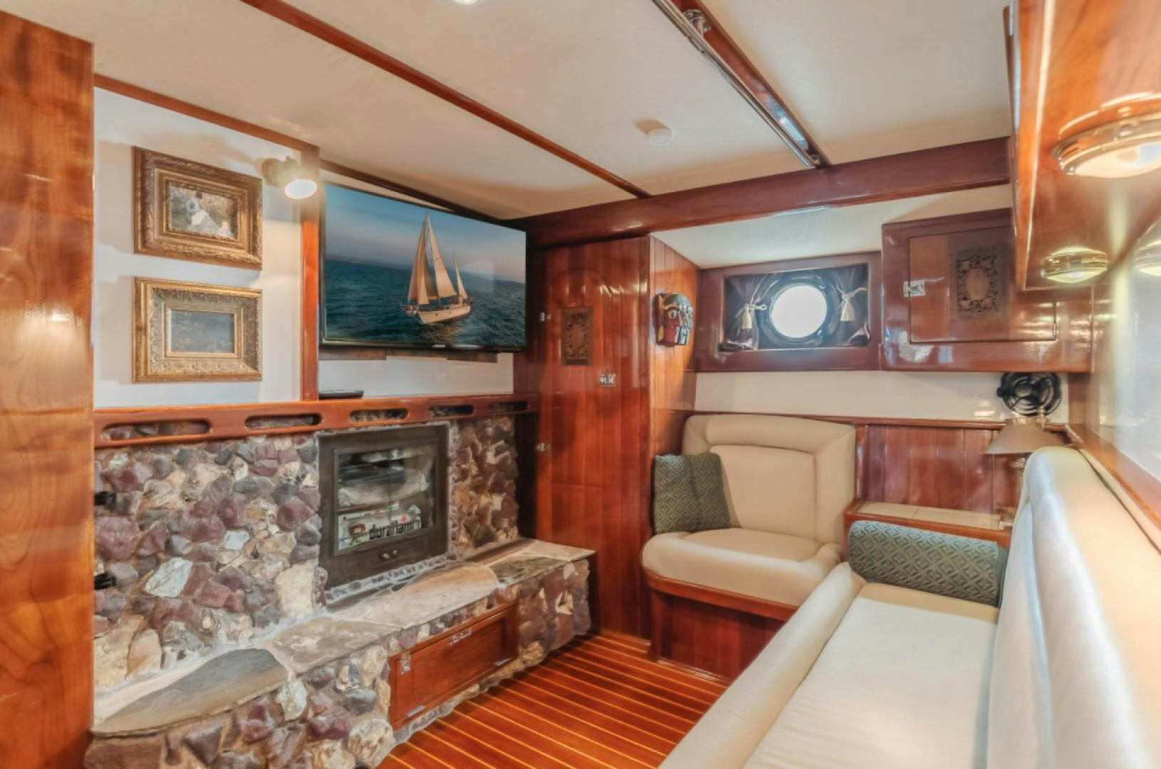 a living room with a fireplace aboard Iolair Mara Yacht for Sale