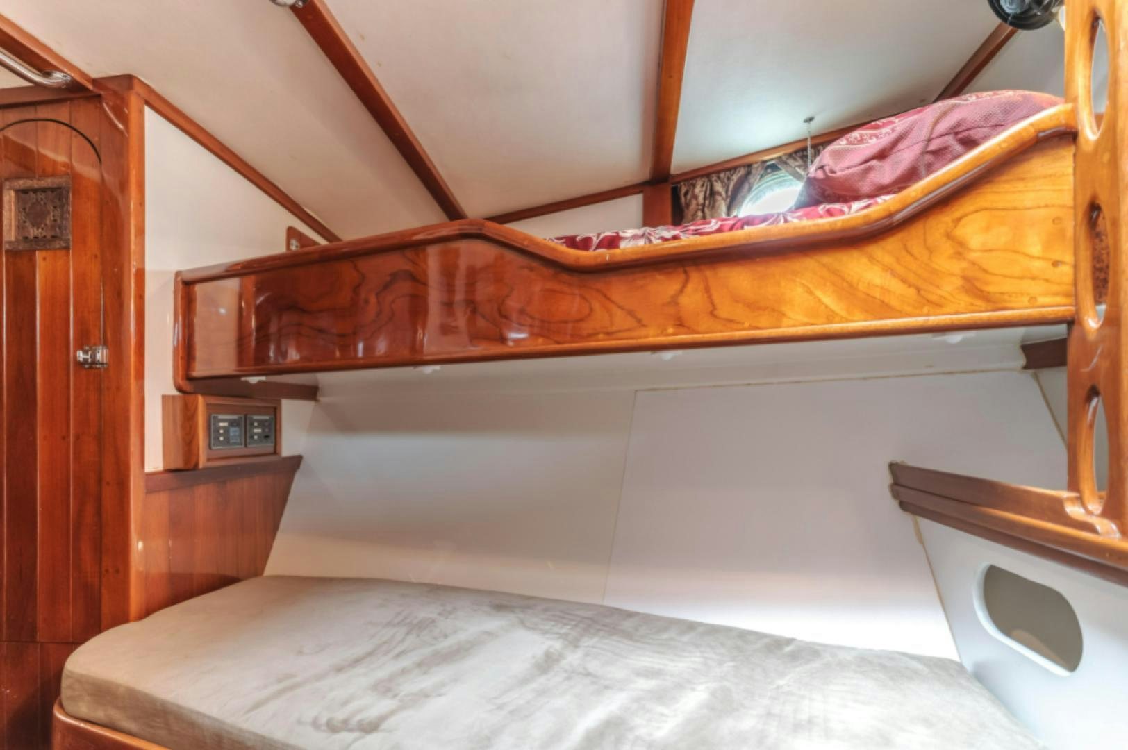 a bed with a mirror above it aboard Iolair Mara Yacht for Sale