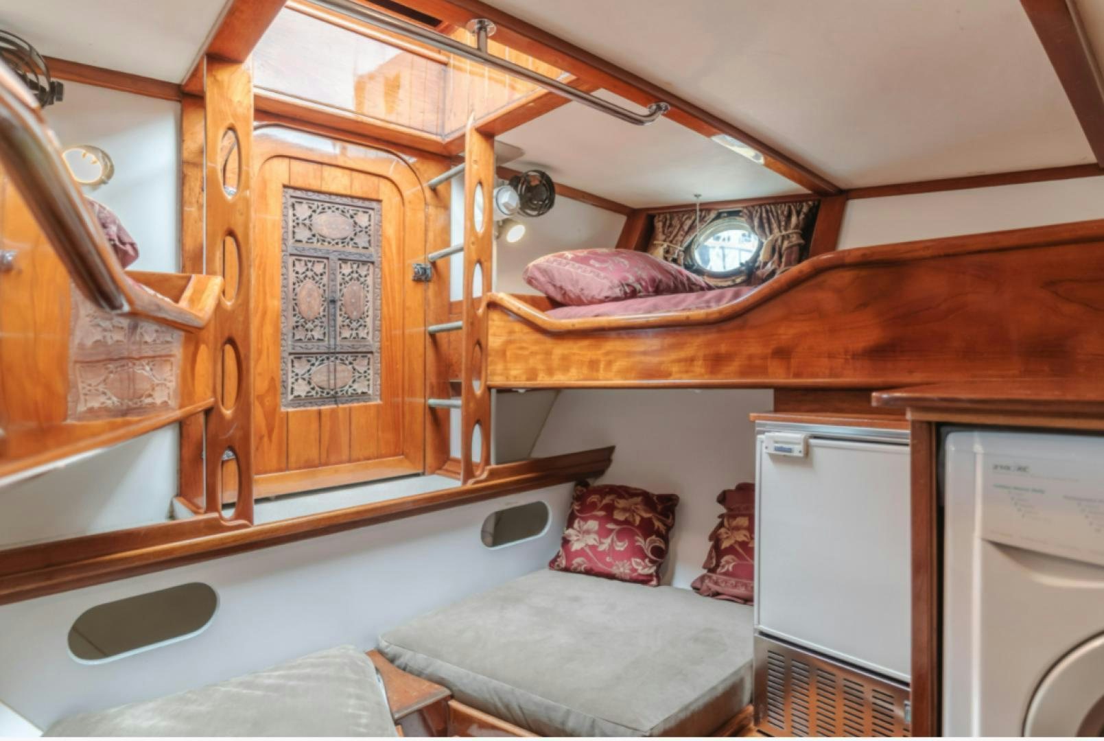 a bedroom with a bed and a mirror aboard Iolair Mara Yacht for Sale