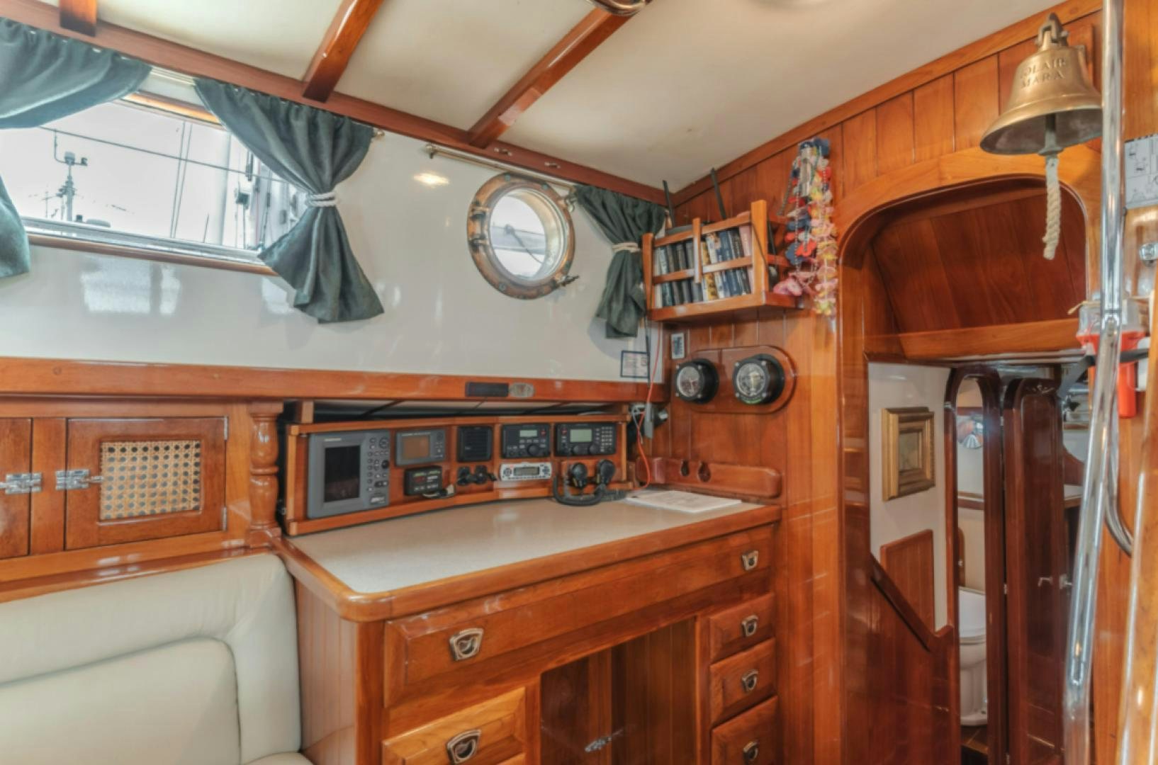 a kitchen with wooden cabinets aboard Iolair Mara Yacht for Sale