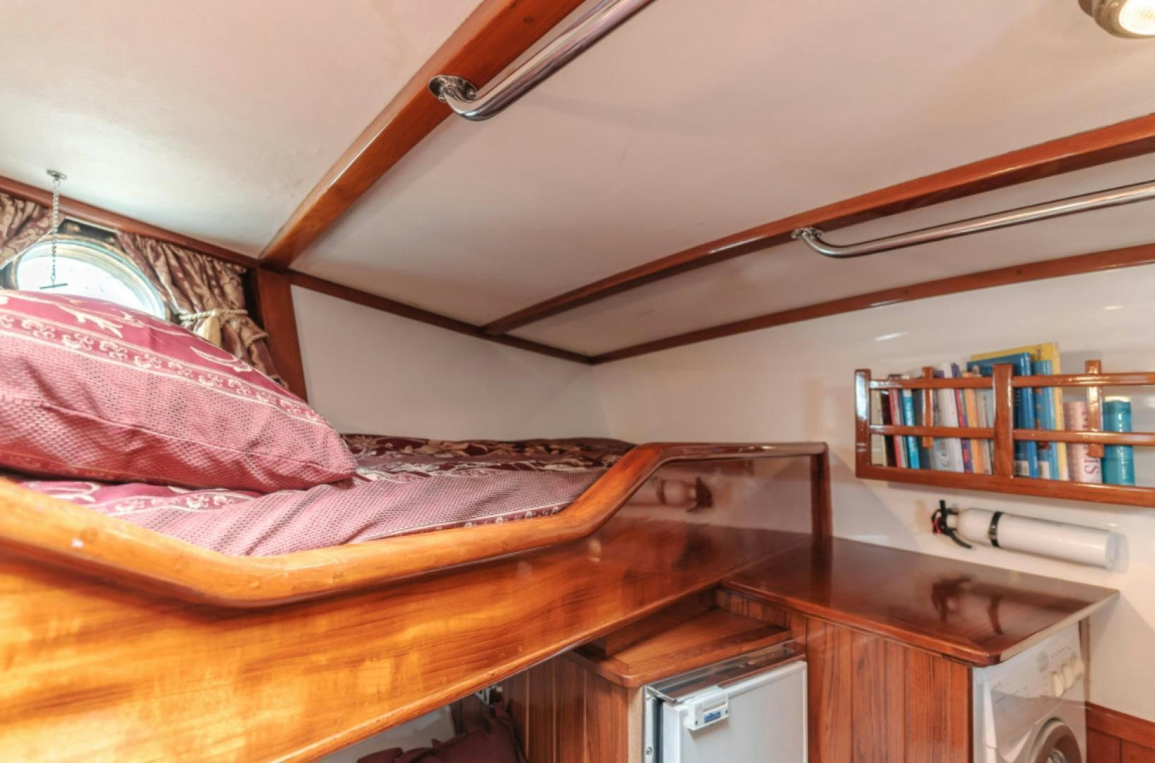 a bed with a pink comforter aboard Iolair Mara Yacht for Sale