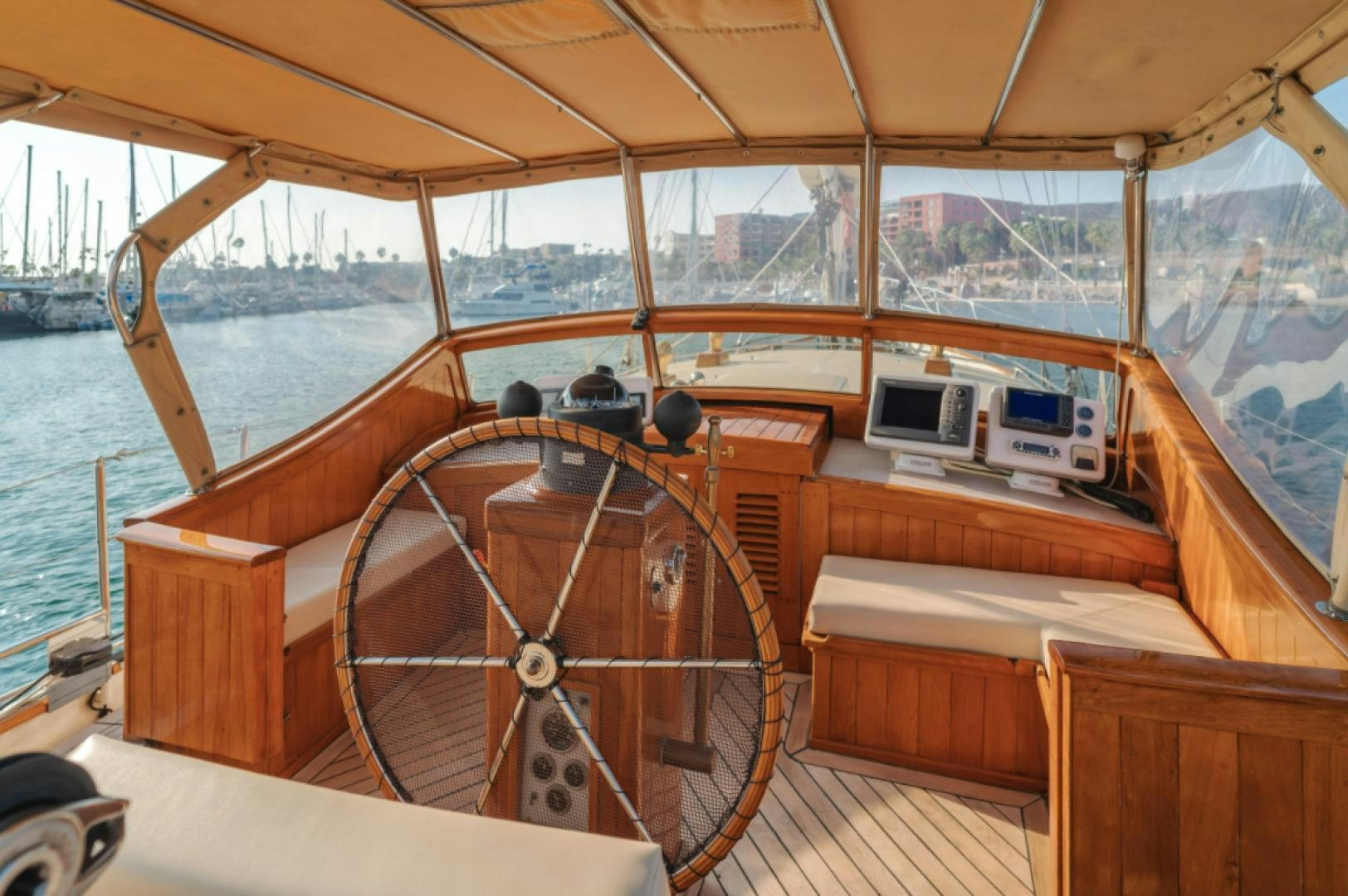 a boat with a wooden steering wheel aboard Iolair Mara Yacht for Sale