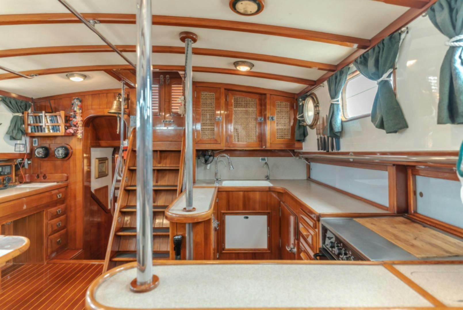 a kitchen with wooden cabinets aboard Iolair Mara Yacht for Sale