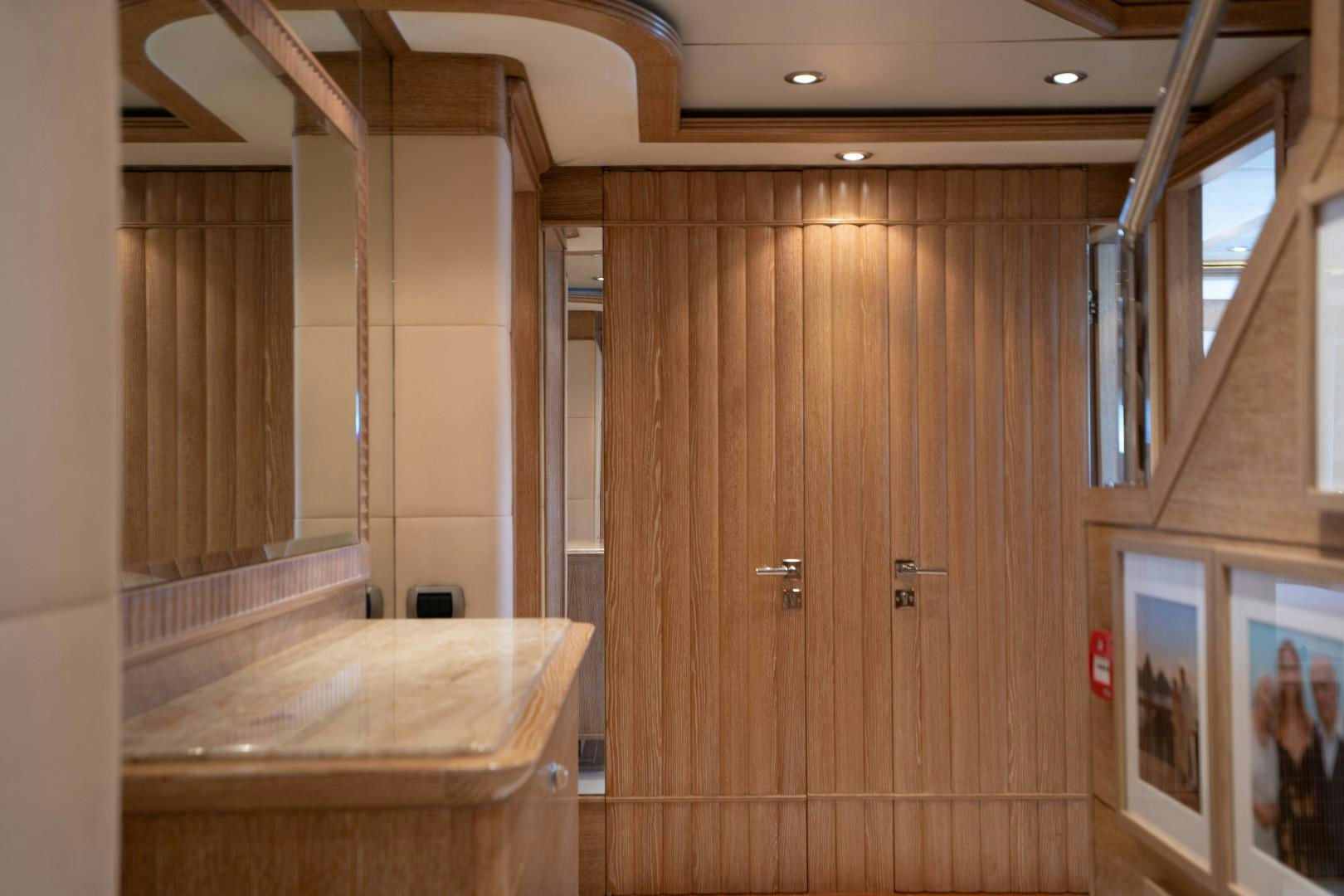 a room with wooden walls and a counter with a wood table and cabinets aboard ARTEMISEA Yacht for Sale