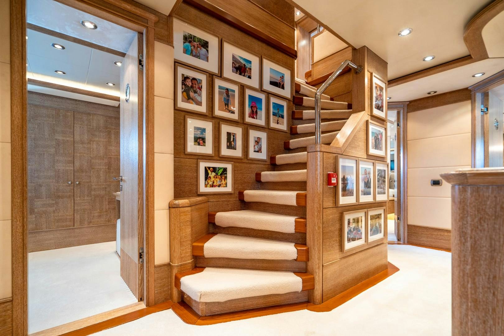a staircase in a room with pictures on the wall aboard ARTEMISEA Yacht for Sale