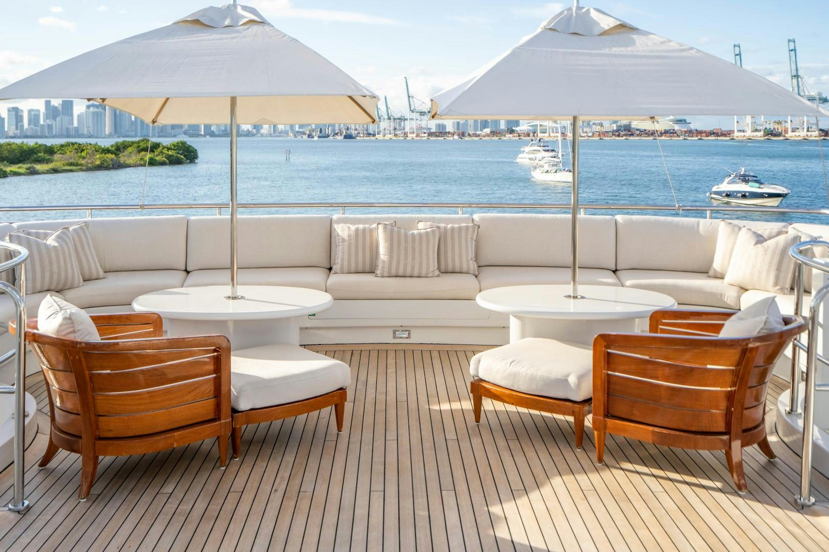 a patio with chairs and umbrellas aboard ARTEMISEA Yacht for Sale