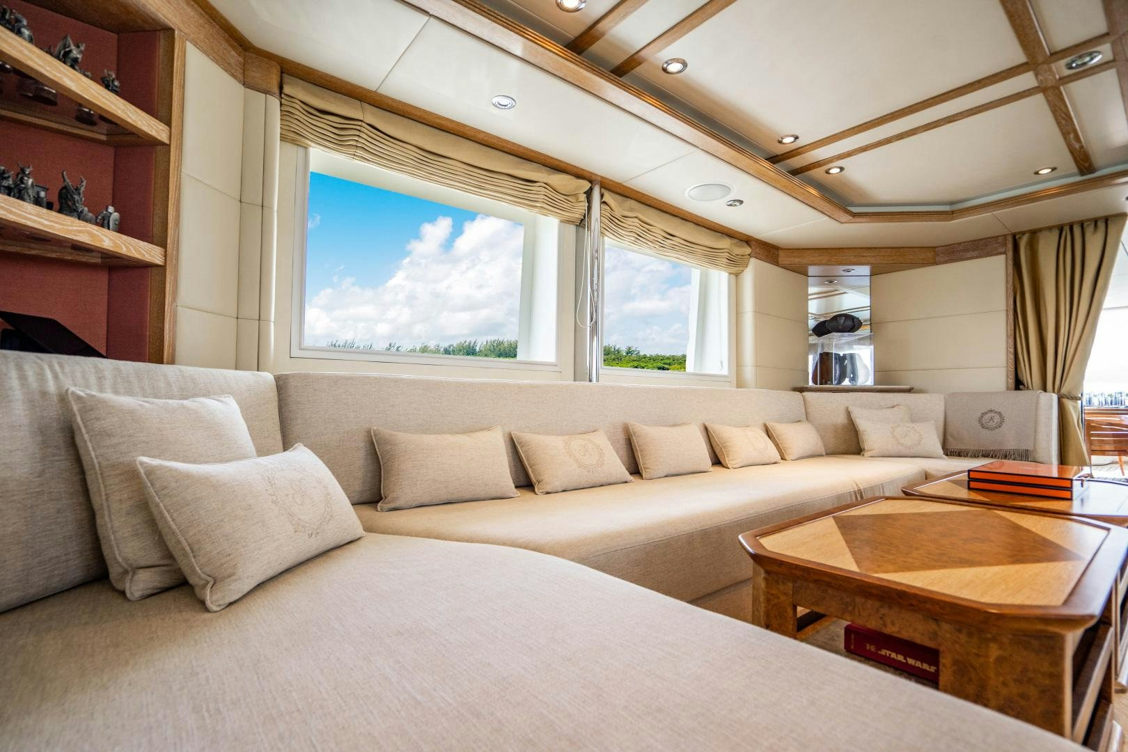 a large living room with a large bed and a table aboard ARTEMISEA Yacht for Sale