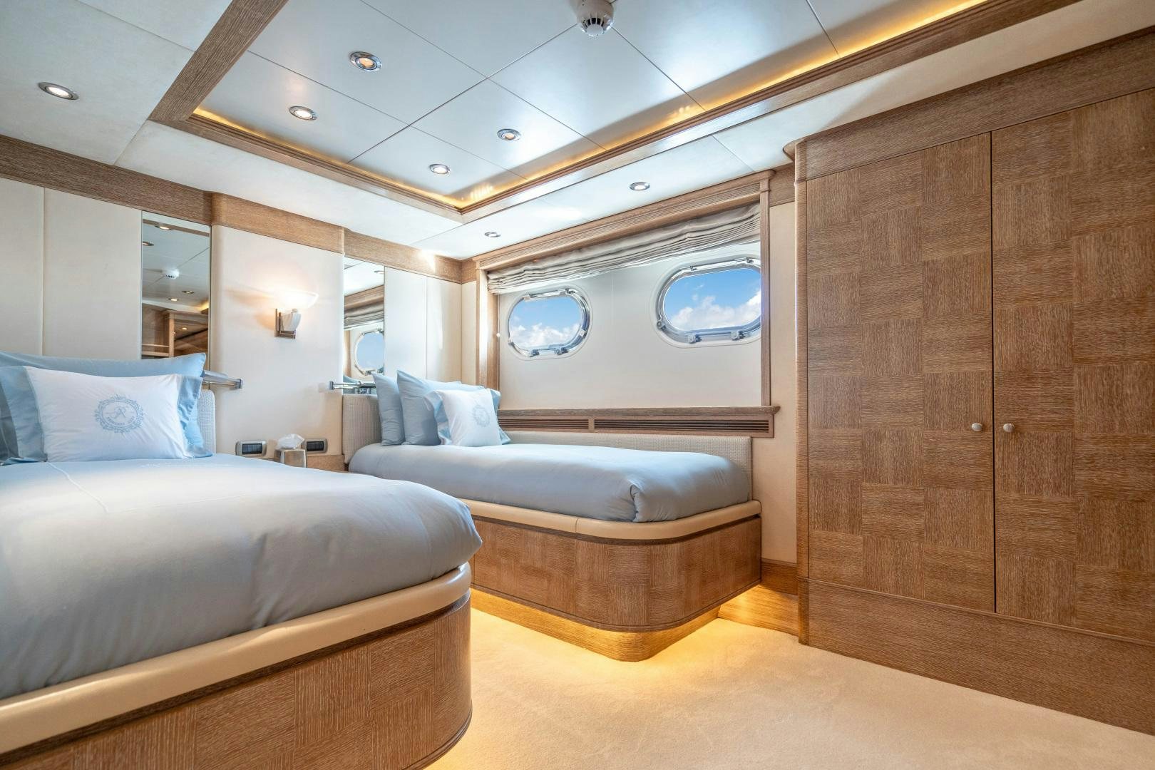 a room with a bed and a wood cabinet aboard ARTEMISEA Yacht for Sale